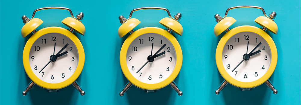 Illustration of yellow alarm clocks on blue background