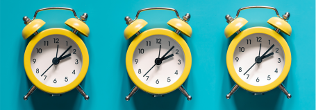 Illustration of yellow alarm clocks on blue background